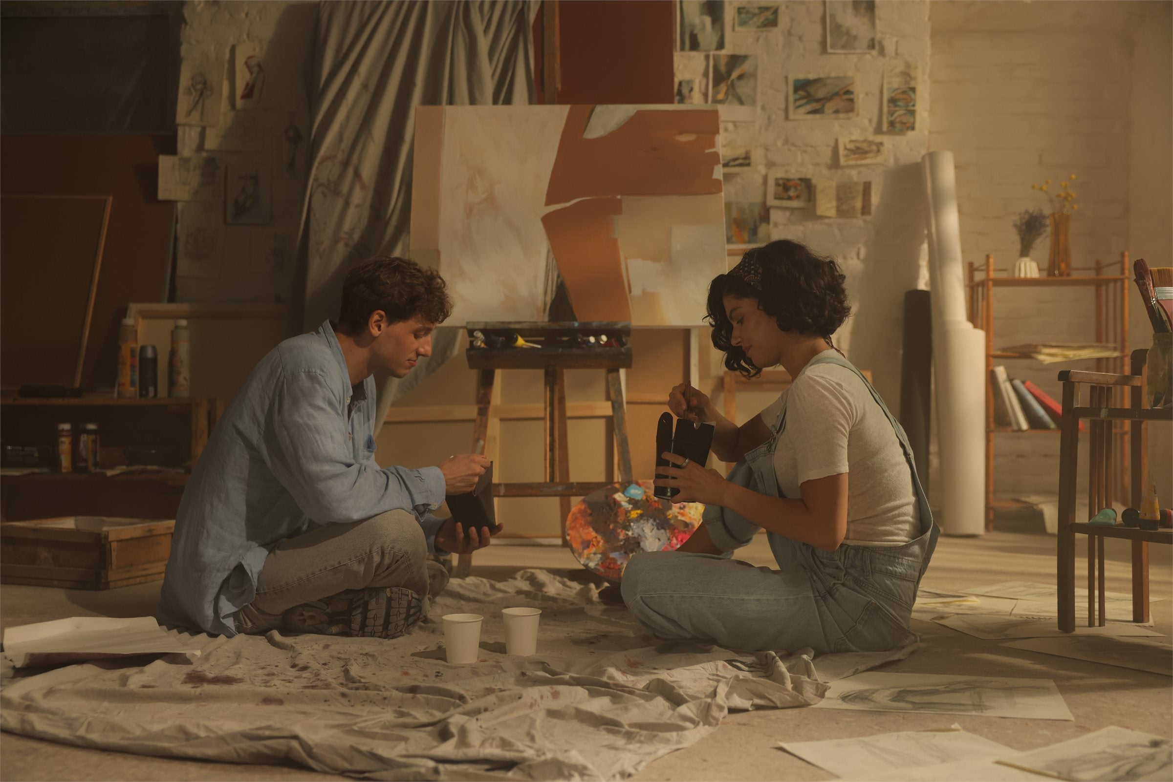 Two people painting together in a studio