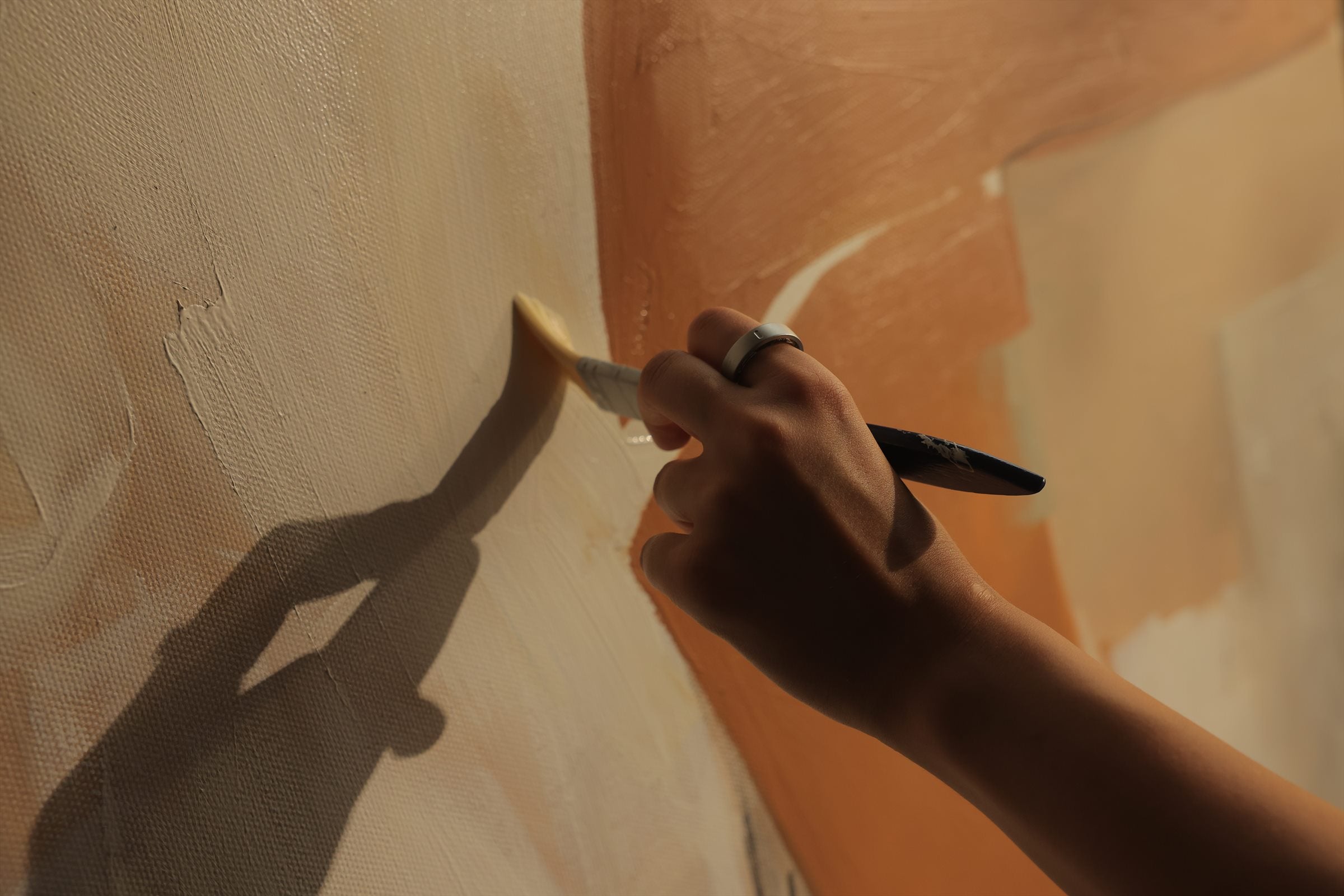A person painting on canvas while wearing evobeing R1